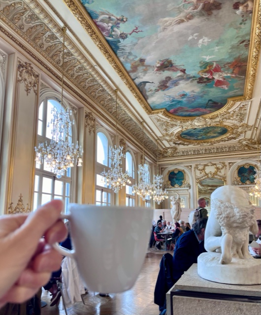 cup of tea held up at the Musee D'Orsay restaurant--a magical tea moment