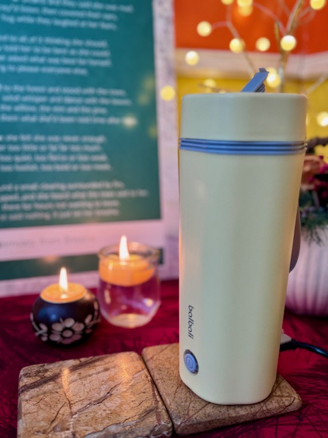 yello balbali portable electric kettle next to two candles on a tea table