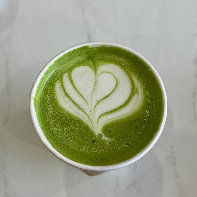 Top down view of a matcha latte with a heart foam art from Humble Cafe in Williston Park