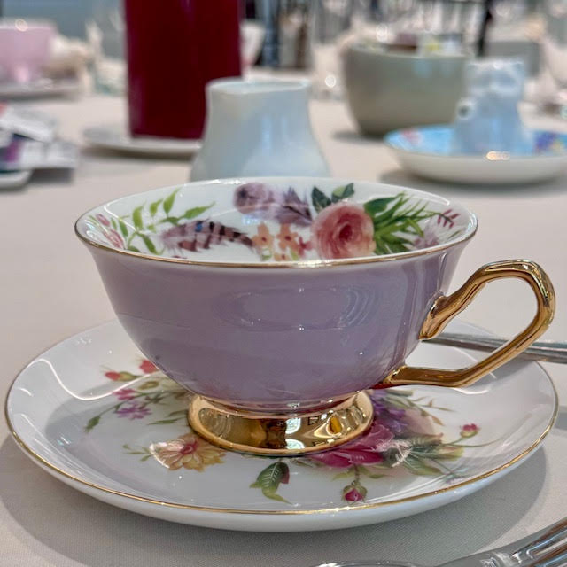 Dusty purple teacup with gold handle and floral interior at the NYBG Wonderland afternoon tea.