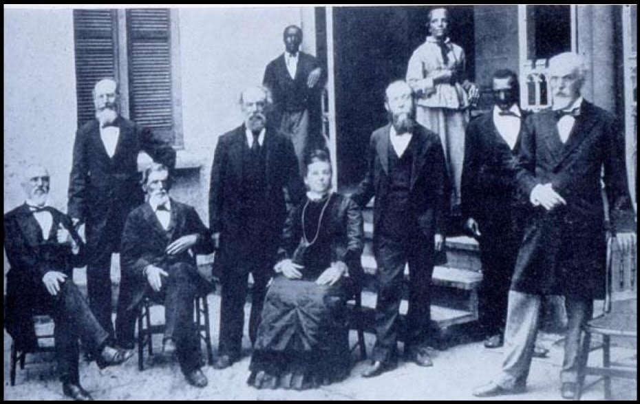 Family photo from 1800s that includes A.A. Solomons (on the far right)  in a grouping with other people standing and seated.