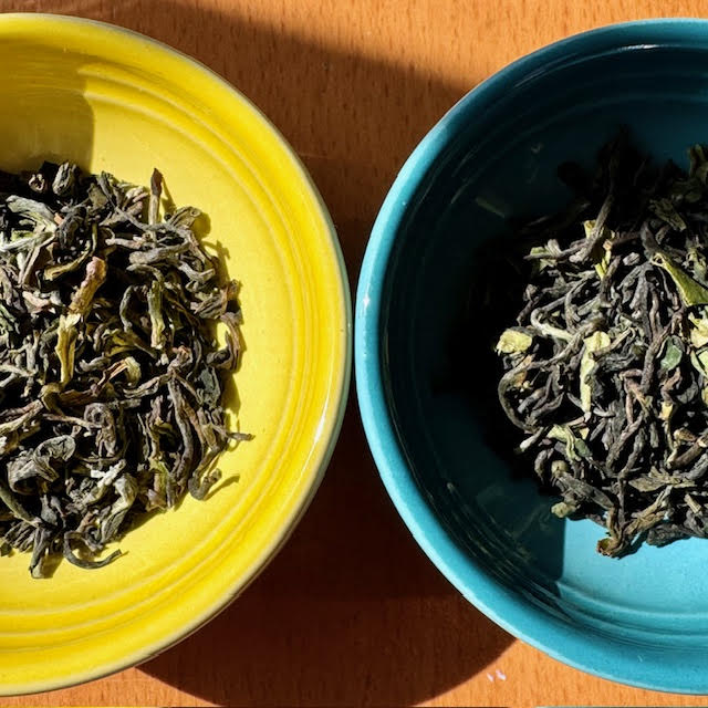 Close-up of two bowls (one yellow, one blue) contained First Flush Darjeeling tea leaves