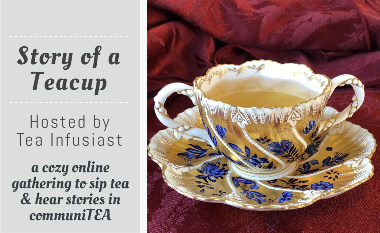 Story of a Teacup, Hosted by Tea Infusiast. Image: White and gold teacup with two handles and cobalt blue flowers on a burgundy tablecloth