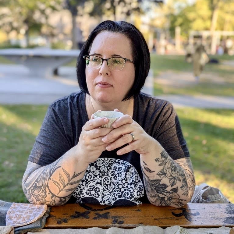 Photo of Annie, a tea-loving storyteller, holding a teacup.