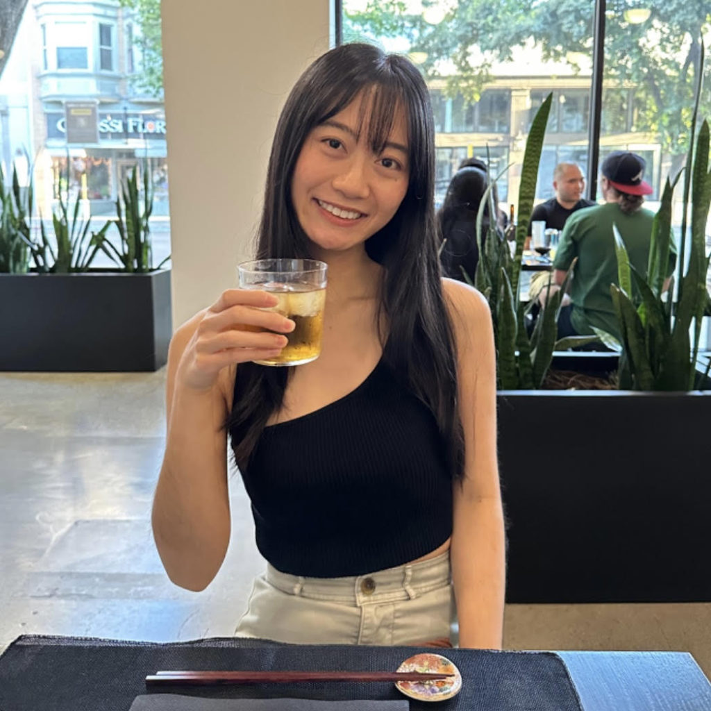 Photo of Katelyn, a tea-loving storyteller, holding a glass of iced tea.