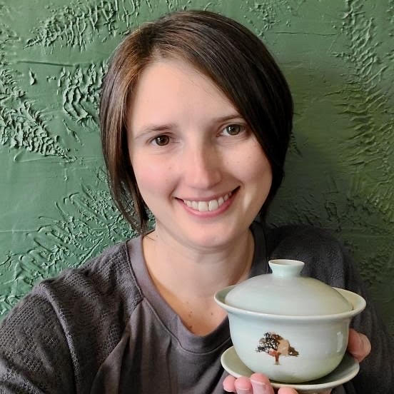 Photo of Michell, a tea-loving storyteller, holding a gaiwan