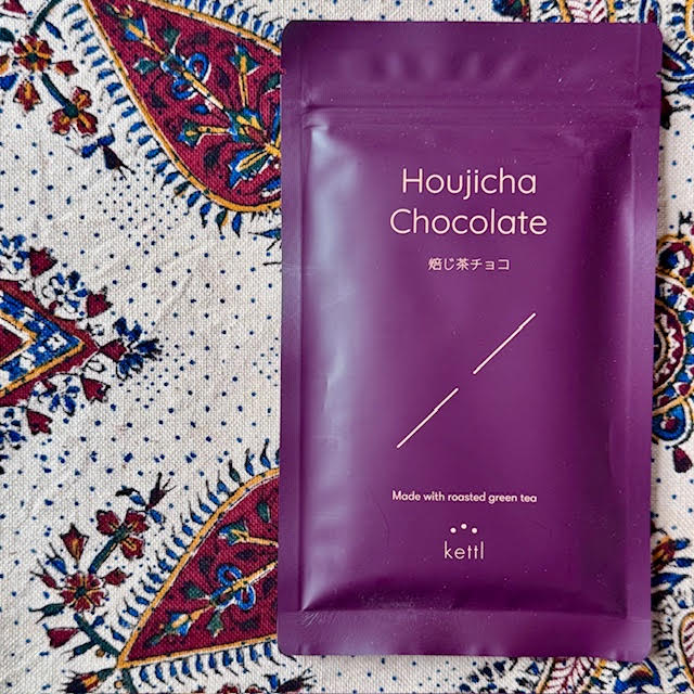 Large, rectangular, aubergine-colored wrapper with gold writing that says "Houjicha Chocolate" by Kettl